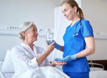 medicine-age-health-care-and-people-concept-nurse-giving-medication-and-glass-of-water-to-senior-woman-at-hospital-ward-image medicine-age-health-care-and-people-concept-nurse-giving-medication-and-glass-of-water-to-senior-woman-at-hospital-ward-image
